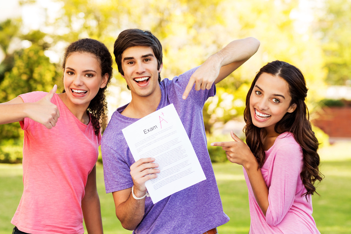 Happy Students Showing Test Result With A+ Grade On Campus