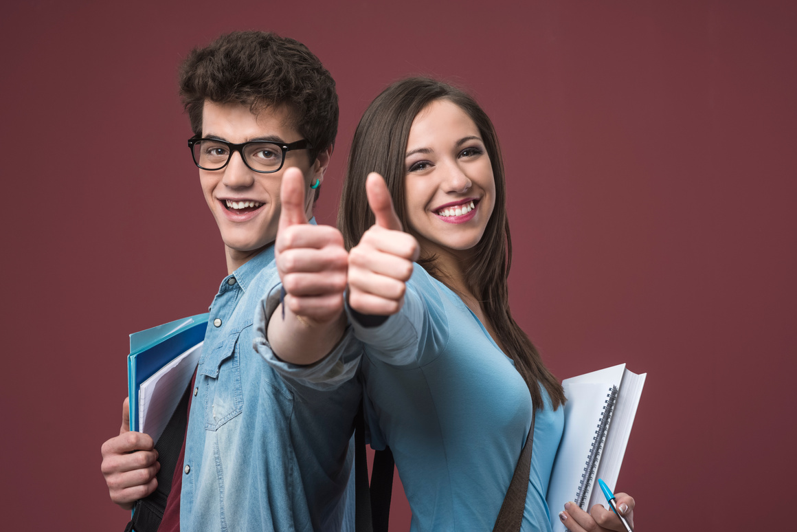 Cheerful students thumbs up